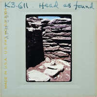 Stone walls and floor with terracotta head on floor.