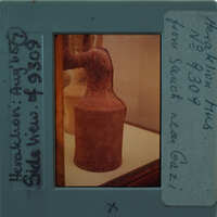 An ancient clay figurine on display.