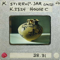 Stirrup jar vase (K.2324) side view on table.