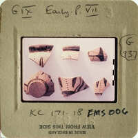 Collection of ancient pottery shards on display.