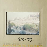 The photo is an old slide, showing a scenic view of a city with historical buildings and a mountainous landscape.