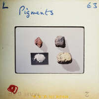 Four rocks with different colors and textures, displayed on a white surface with labels.