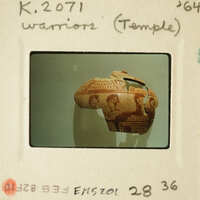 Ancient Greek vase with figures on display.