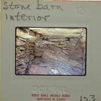 Slide showing an interior view of a stone structure with layers of rock and soil.