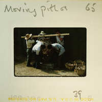 Men working on a project with wood and tools.