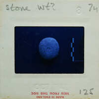 A photograph of a blue, spherical object with an old-fashioned film strip border.