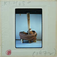 Coiled terracotta fragment around frame holding it upright. K1.465