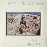 "Old photo of ruins with stone walls and blue sky."