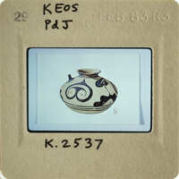 A photograph of an antique vase with intricate designs on its surface.