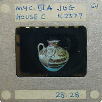 Reassembled lay jug with intricate design on black background K.2377.