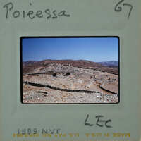 A photograph of an ancient archaeological site with stone ruins and a clear sky.