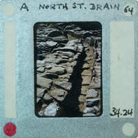 A photograph of a rocky path with a film strip label on it.