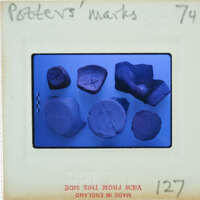 A collection of pottery shards on a blue background with labels and numbers.