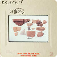 Broken pottery pieces on a white background.