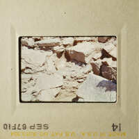 An image of a rocky landscape with a yellowish hue, possibly taken from an airplane window.