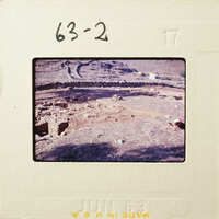 Aerial view of an ancient archaeological site with dirt and stone ruins.