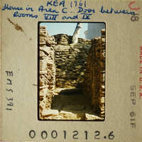 Old photograph of stone ruins with visible damage and erosion, possibly part of an ancient structure.