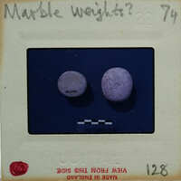 Two marble weights on a scale.