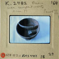 Old clay pot with cracks on display.