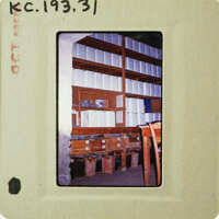 A photograph of a storage room with shelves filled with boxes and papers, taken on film.