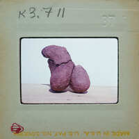 Two brown objects resembling a human figure on a white surface.