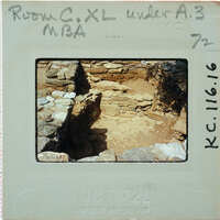 A photograph of an archaeological site with stone ruins and a dirt floor, taken on October 16, 1972.