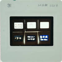 A close-up image of a small, rectangular object with various printed images and texts on it.