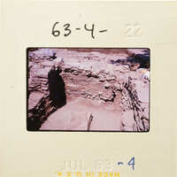 Ancient ruins with stone structures, possibly part of an archaeological site.