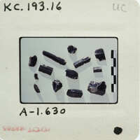 Photograph of a collection of stone items with labels and measurements on a white background.