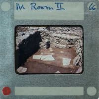A photo of an old stone room with a film strip border.