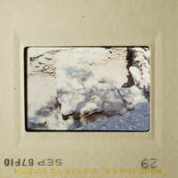 This photo shows an outdoor scene with rocks and dirt, possibly taken from a high vantage point.