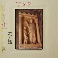 Ancient stone relief depicting two figures, possibly gods or mythological characters.