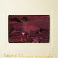A vintage photo of a house with a red roof, set against a backdrop of hills and trees.