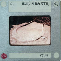 A photograph of a cave with a stalagmite and stalactite formations, displayed on an old film strip with handwritten labels.