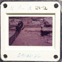 Ancient ruins with stone walls and pathways, captured on an old photograph.
