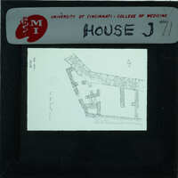 Black and white architectural drawing of a building on a transparency, labeled with "HOUSE J71".