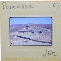 A slide showing a desert landscape with mountains and vegetation.