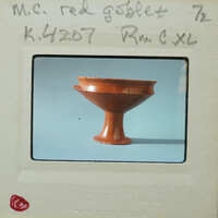 Brown ceramic goblet (K.4207) with a handle on display.