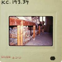 Photo of a wooden table with various items on it, taken from an old photograph and placed within another frame.