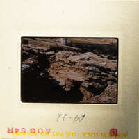 Ancient ruins with visible stones and dirt, photographed on film.