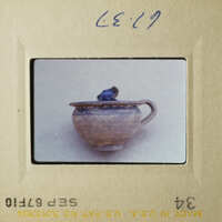 Two photos showcasing an antique blue ceramic cup with a handle, placed on a white surface.