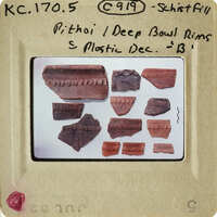 Old pottery shards on display with labels.