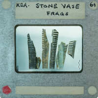 The image shows a collection of broken stone vase fragments.