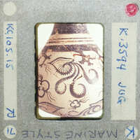 The image shows a small, intricately decorated vase (K.3594) with an octopus design on it.