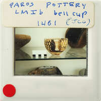 A photograph of an ancient Greek cup with gold decoration.