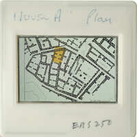 Aerial view of a city street with annotations, including a highlighted area and written notes.