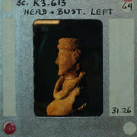 Terracotta figurine fragment (K3.613) from side showing head and torso in profile.