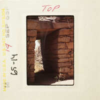 Ancient stone ruins with sunlight streaming through an opening.