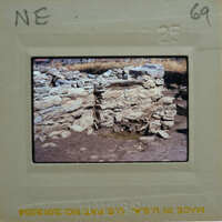 Old stone ruins with a muddy ground, captured on film.