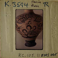 Decorative vase with intricate patterns on an antique paper mount.